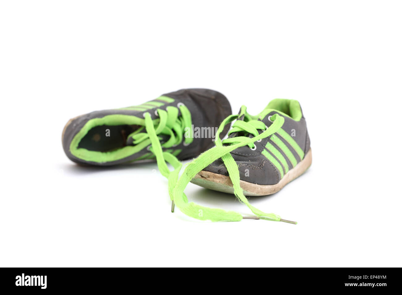 children's sneakers with green shoelaces on a white background Stock Photo