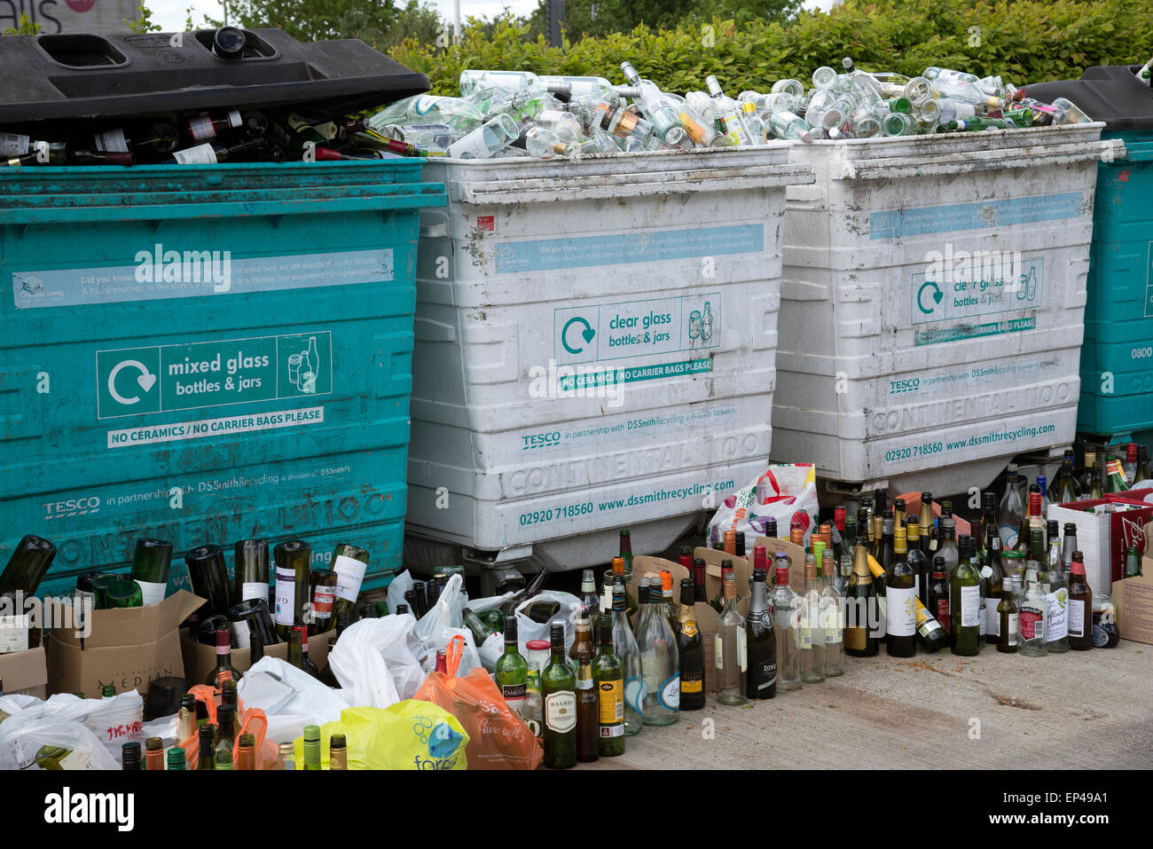 Glass recycling bins which are overfull await collection Stock Photo