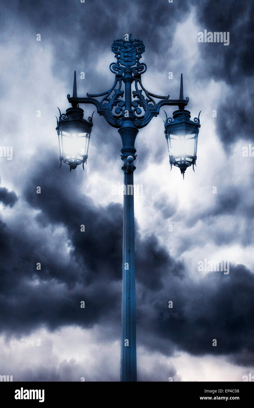 a victorian lamp post with stormy clouds Stock Photo