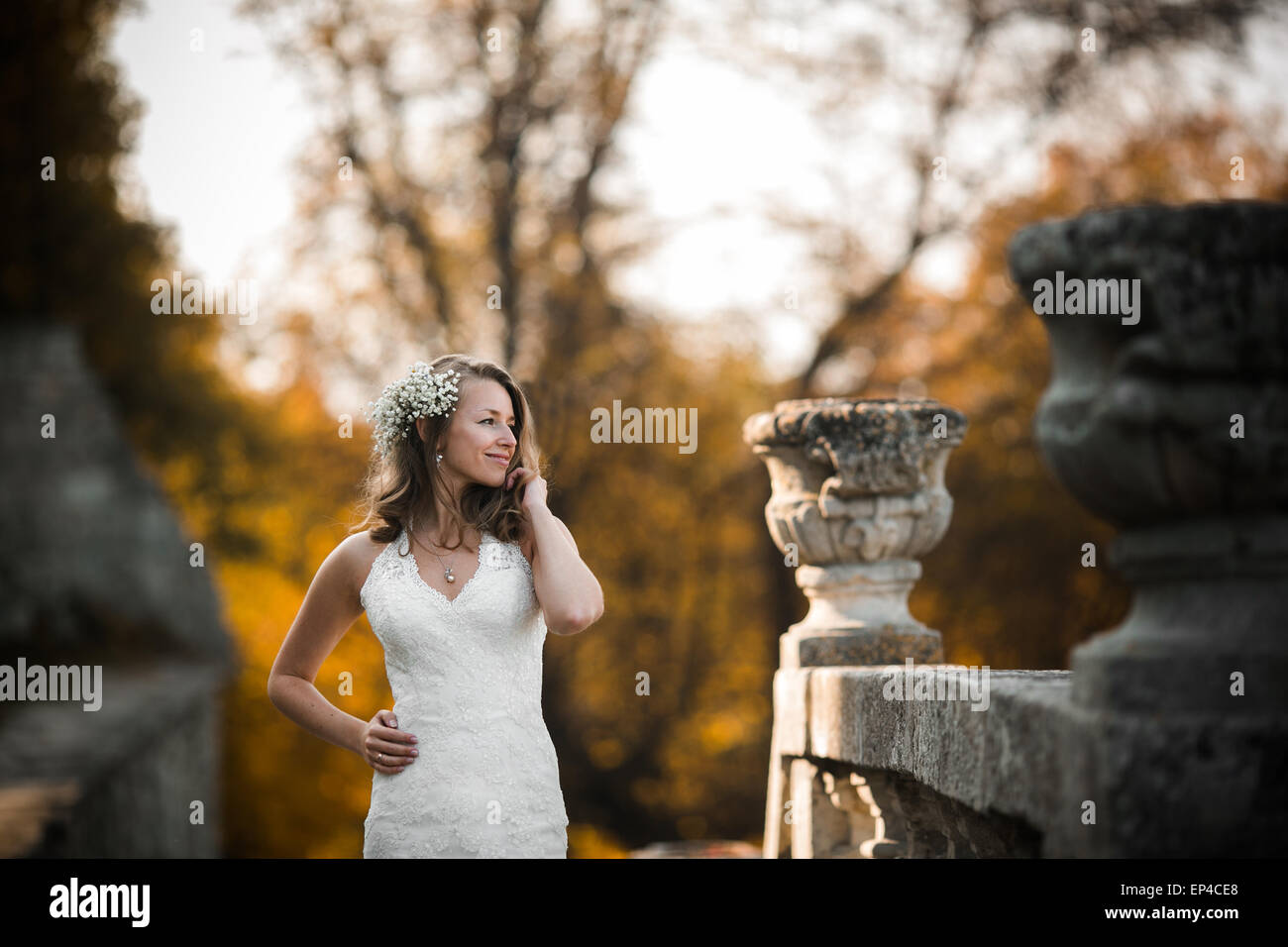 Beautiful bride posing and smiling on the stone steps Stock Photo - Alamy
