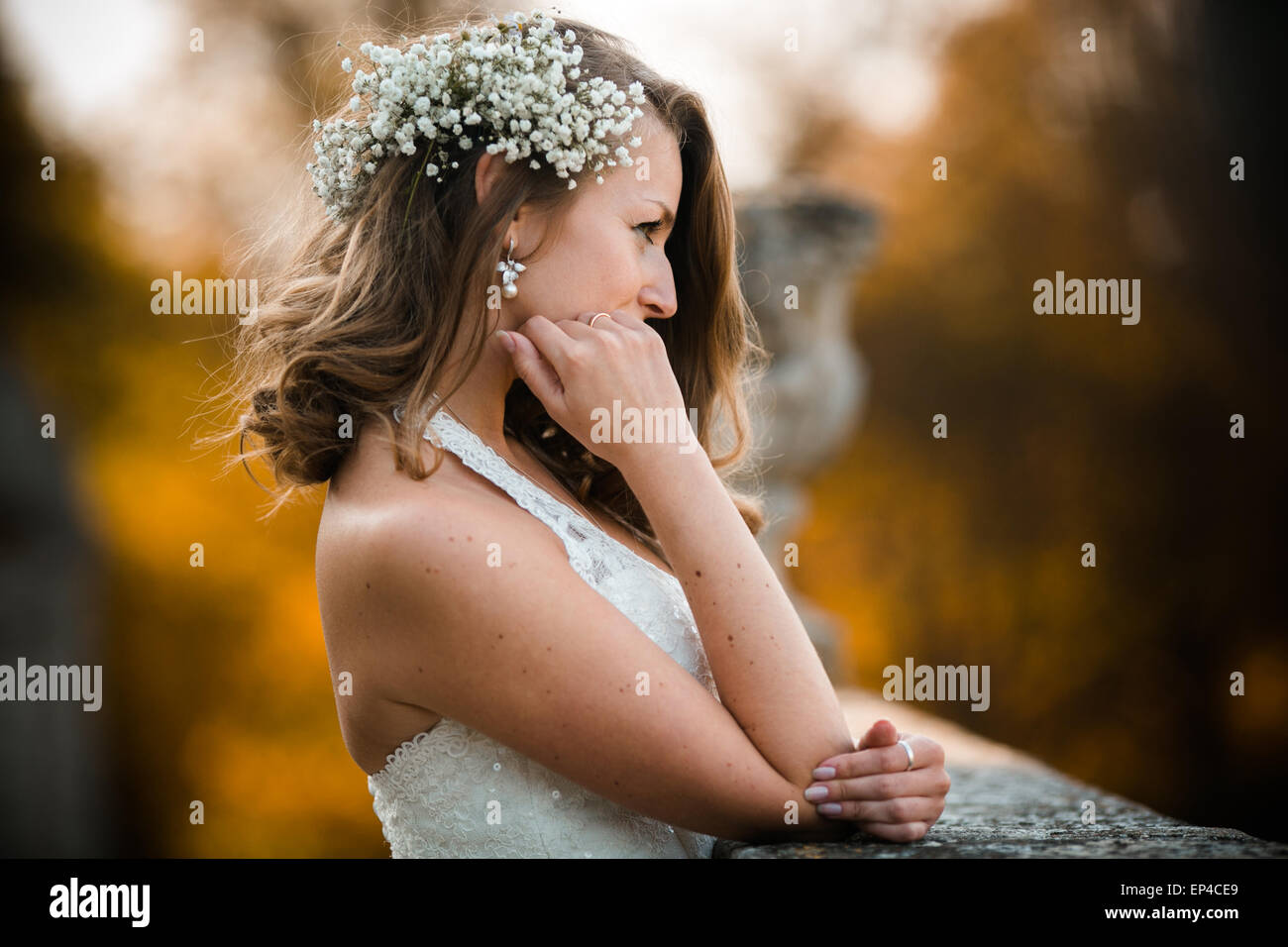 Beautiful bride posing and smiling on the stone steps Stock Photo - Alamy