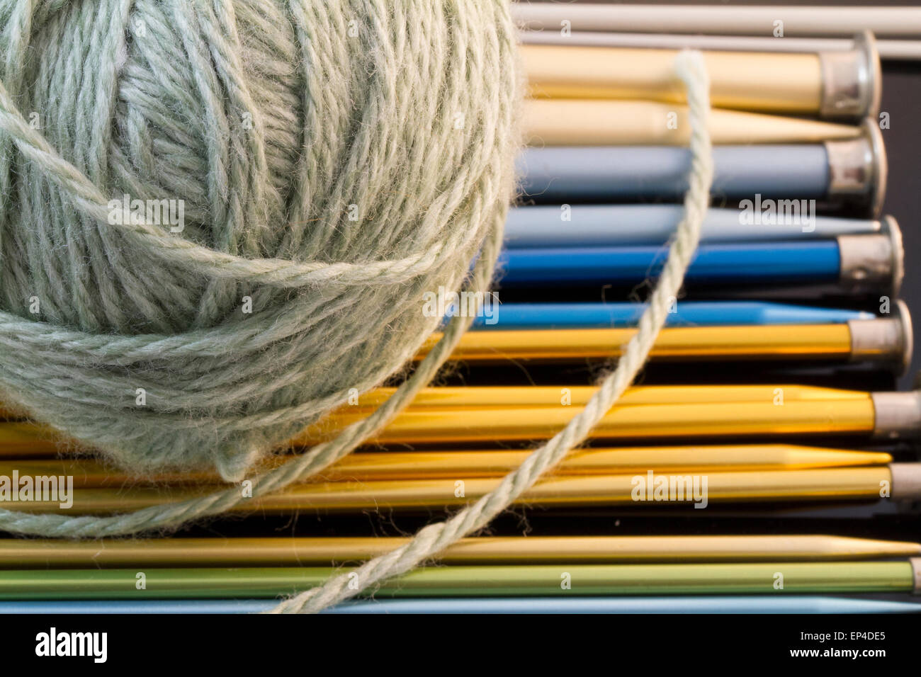 Green Yarn And Various Sizes Of Knitting Needles In Green Yarn And Various Sizes Of Knitting Needles In