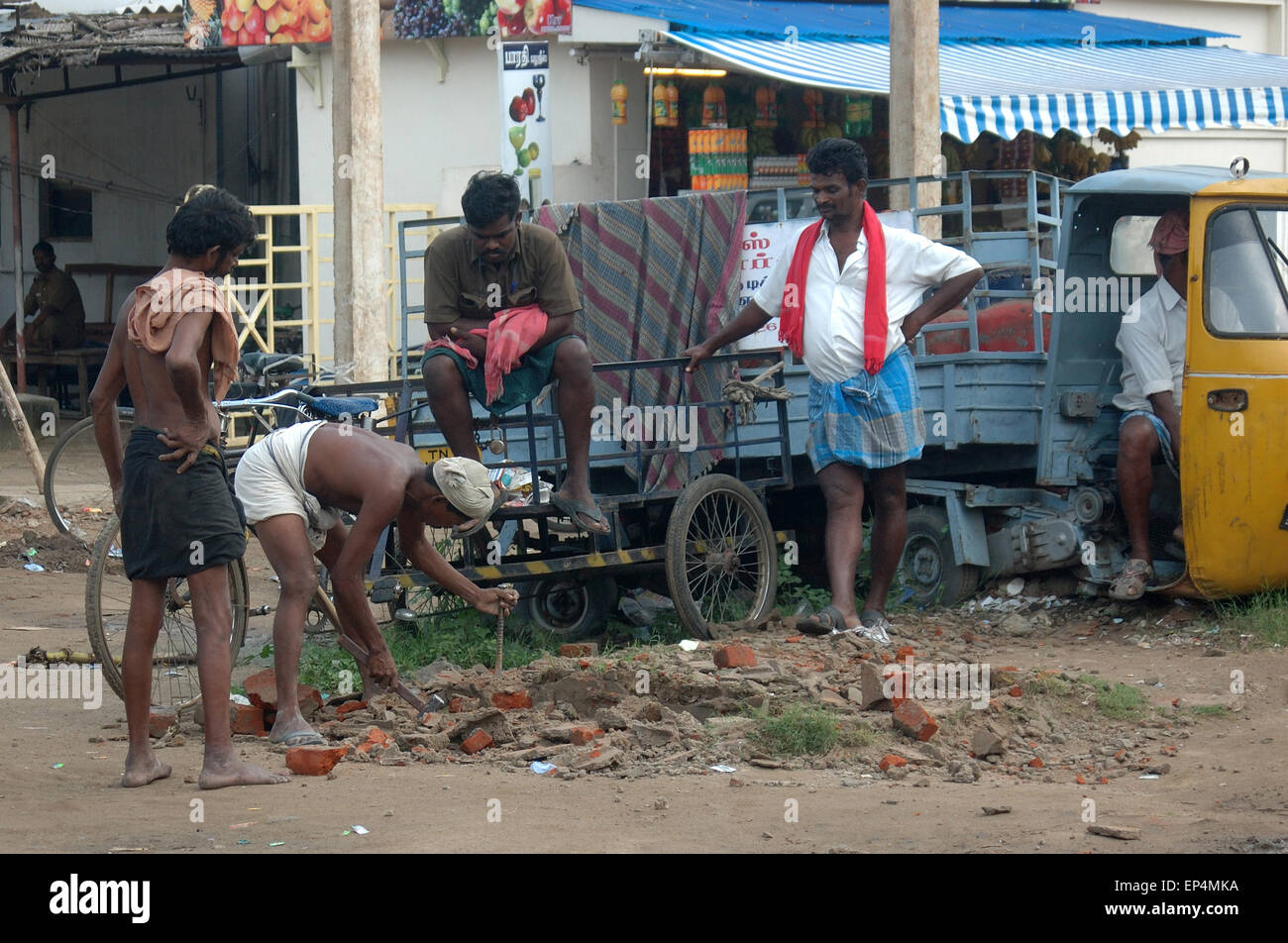 TAMIL NADU, INDIA, circa 2009: An unidentified team of men 'hard at work'  on road repairs, circa 2009 in Tamil Nadu, India. Stock Photo