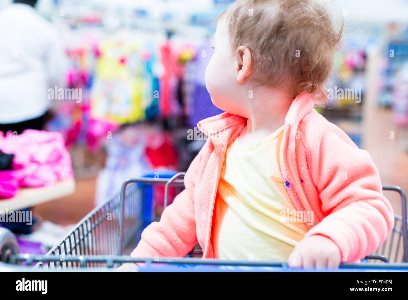 Cute toddler girl sitting in shopping cart at the grocery store Stock ...
