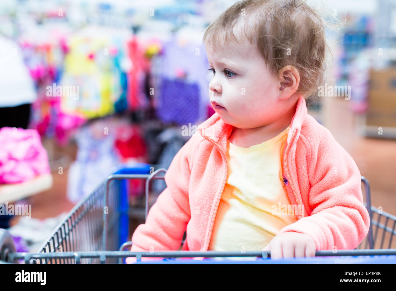 Cute toddler girl sitting in shopping cart at the grocery store Stock ...