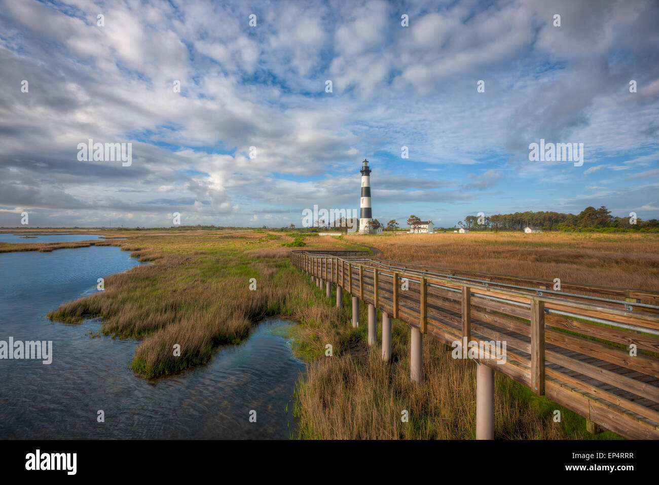 The Bodie Island lighthouse and adjacent boardwalk in Cape Hatteras National Seashore in the Outer Banks of North Carolina. Stock Photo