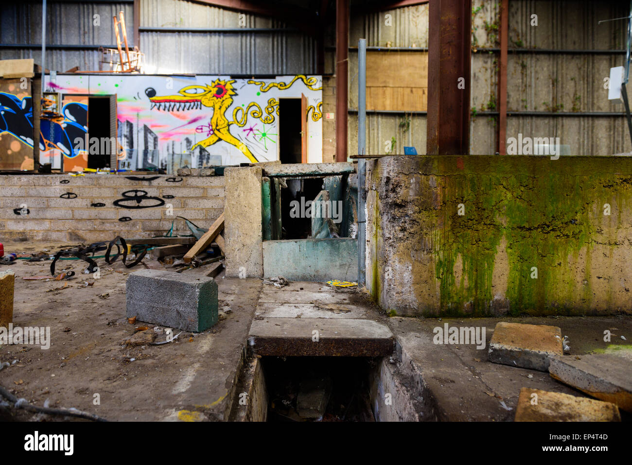 Amazing graffiti in a derelict warehouse, destroyed to the point of being dangerous Stock Photo