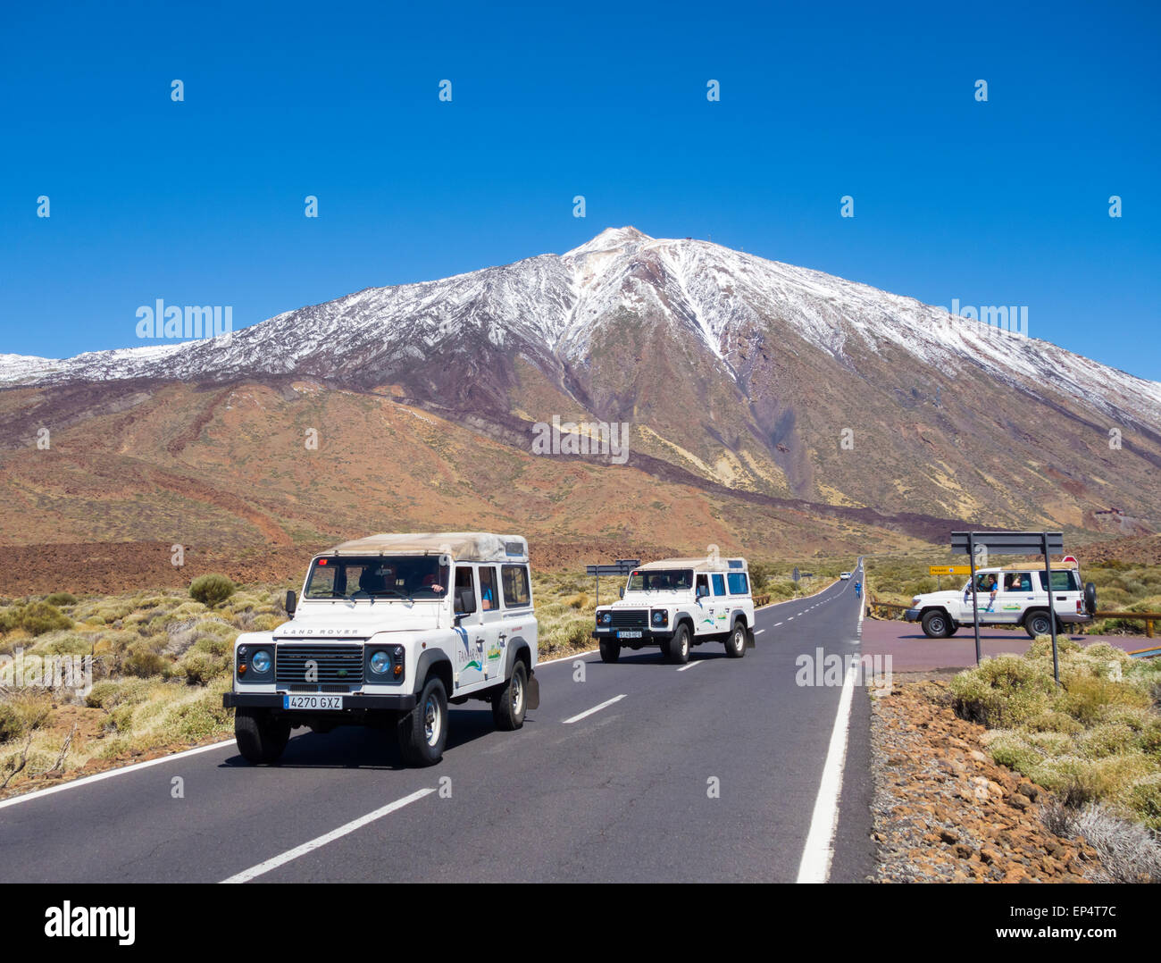 Tourists on Jeep Safari tour near snow covered El Teide in Teide National Park on Tenerife, Canary Islands, Spain Stock Photo