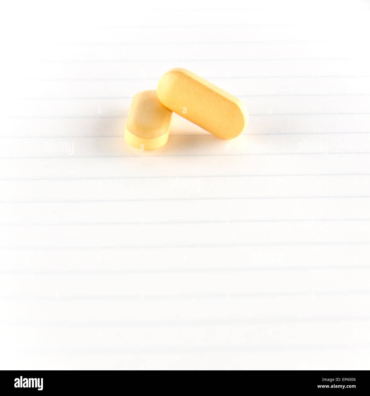 two pills on notebook concept seriousness Stock Photo