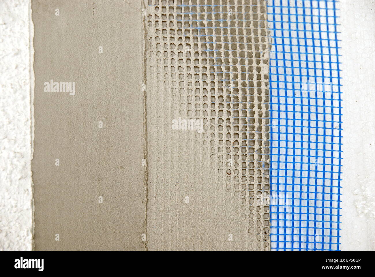 Closeup of facade layers over styrofoam insulation, mesh, plaster