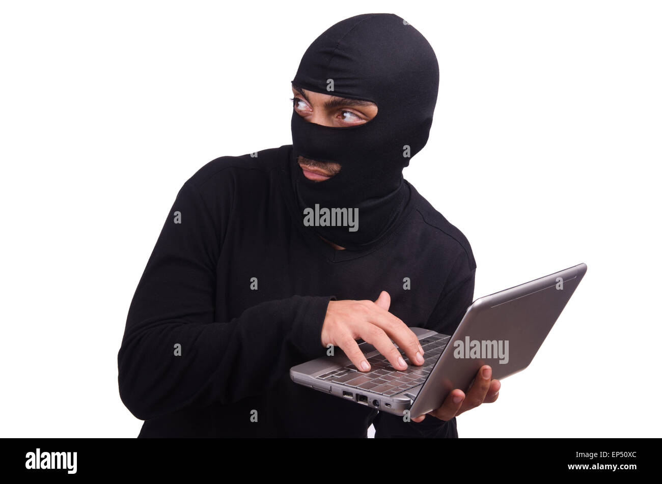 Hacker with computer wearing balaclava Stock Photo - Alamy