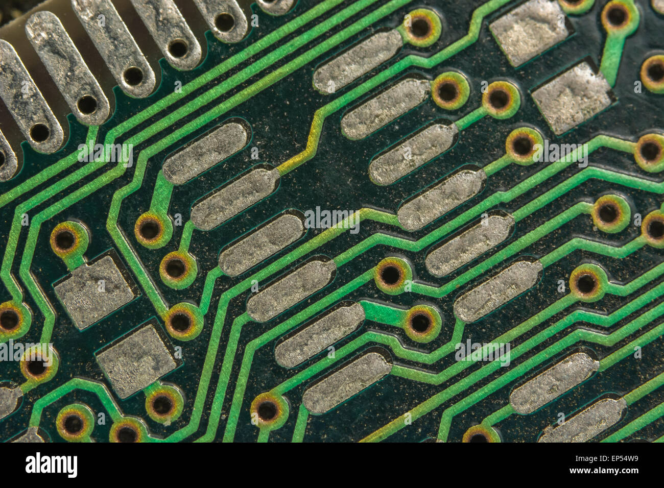 Macro-photo of the contacts and solder points of a piece of PCB associated with PC memory sticks. Wiring inside computer. Stock Photo
