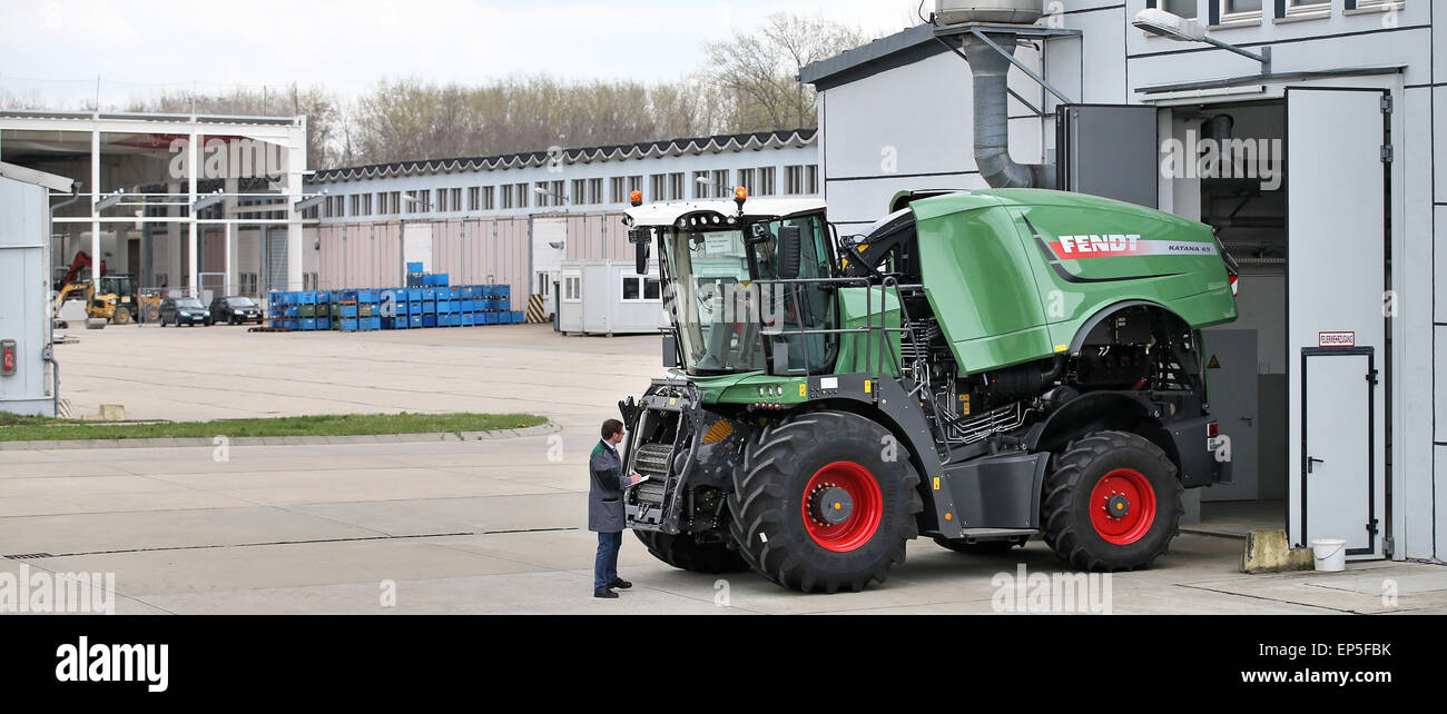 Two employees do the quality check of a Fendt Katana 65 corn chopper in  front of a former tank maintenance hall in Hohenmoelsen, Germany, 17 April  2015. The AGCO Hohenmoelsen GmbH produces