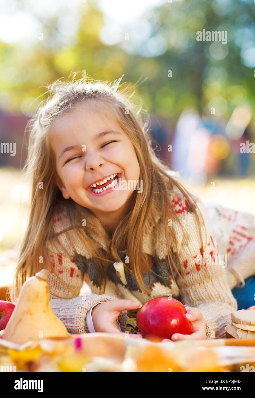 Adorable little girl with autumn leaves in the beauty park Stock Photo ...