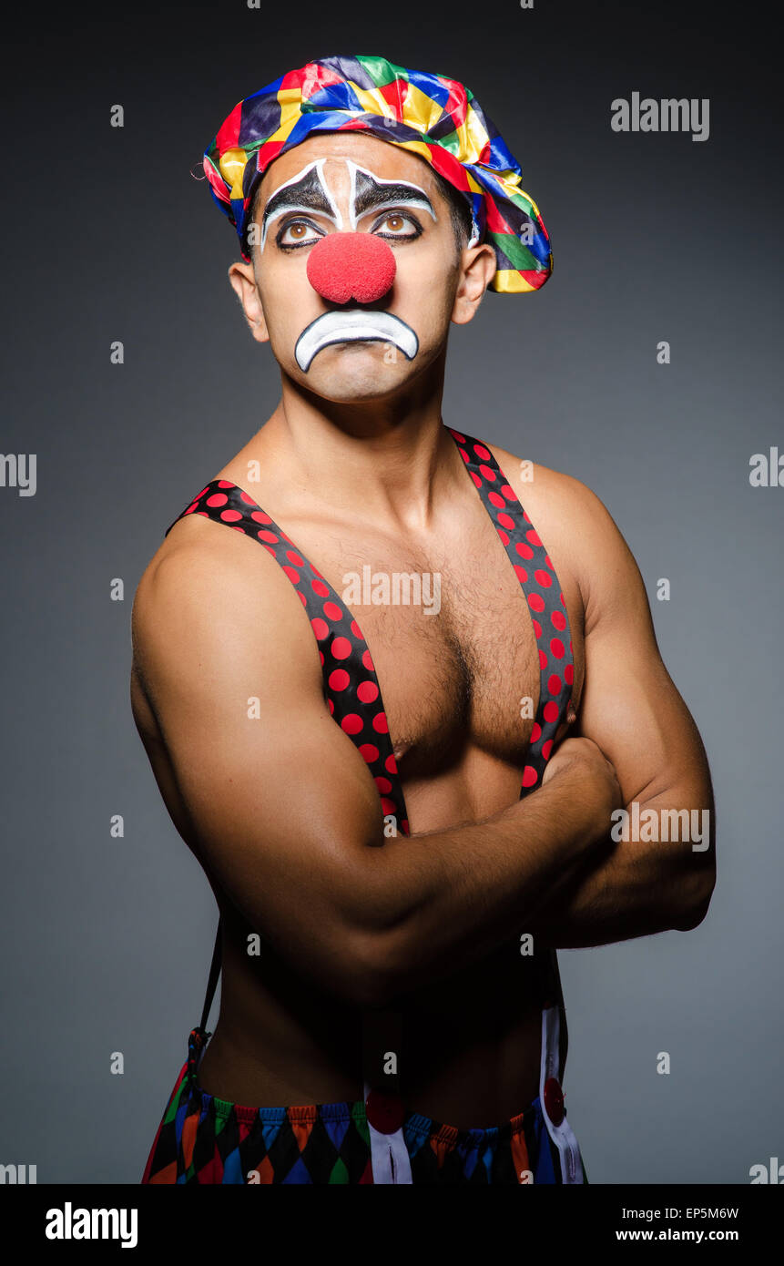 Sad clown against dark background Stock Photo