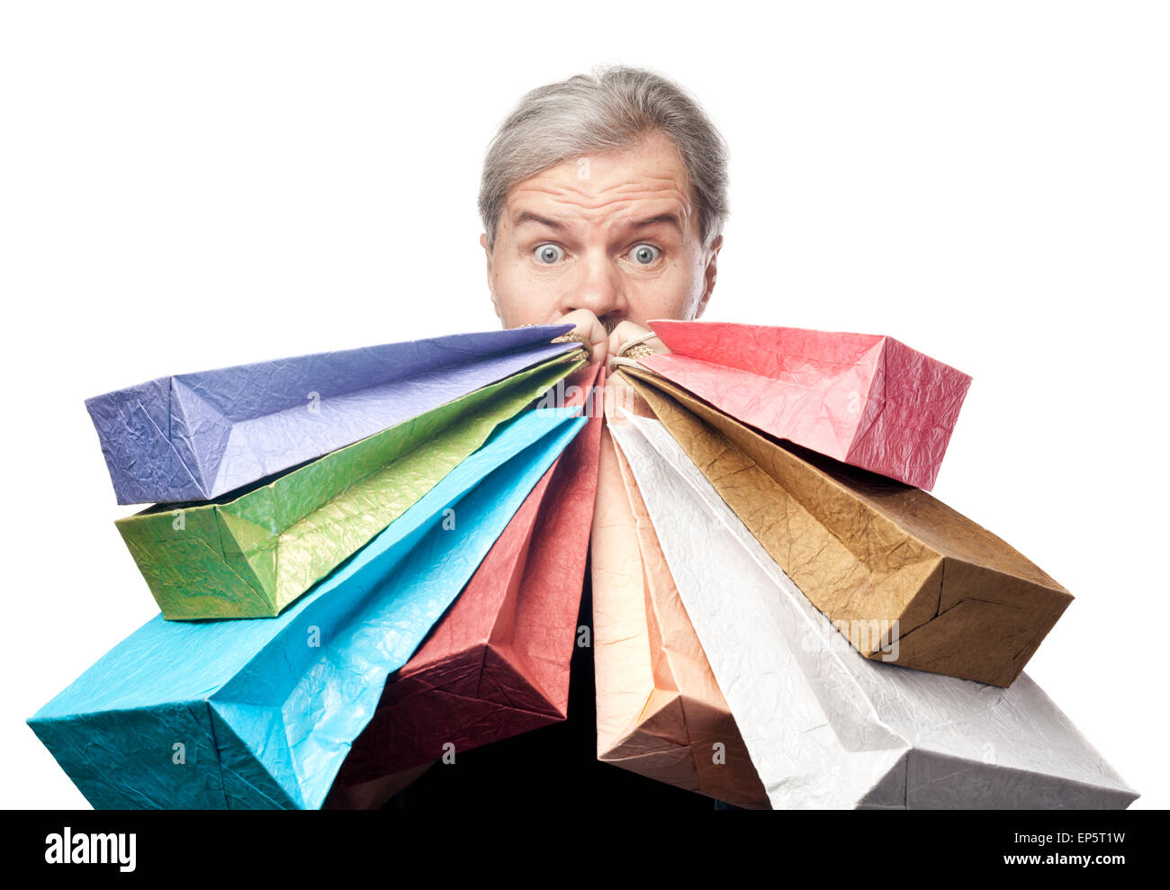 surprised mature man holding shopping bags Stock Photo