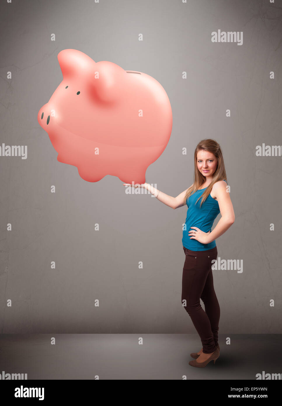 Young girl holding a huge savings piggy bank Stock Photo - Alamy