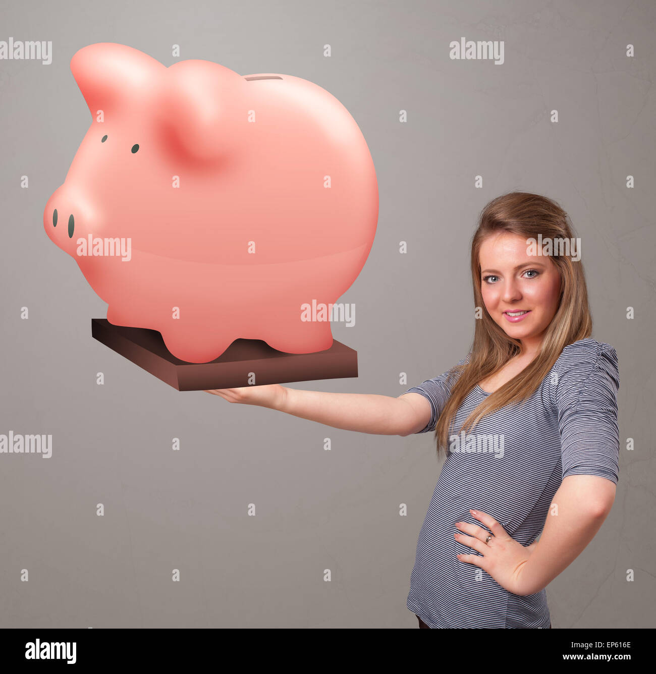 Young girl holding a huge savings piggy bank Stock Photo - Alamy