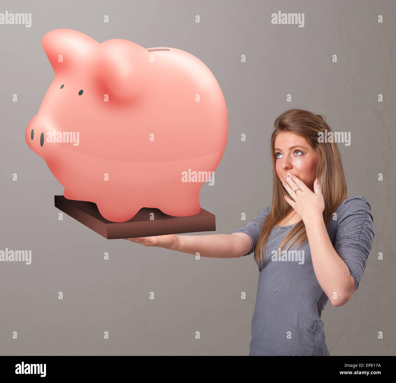 Young girl holding a huge savings piggy bank Stock Photo - Alamy