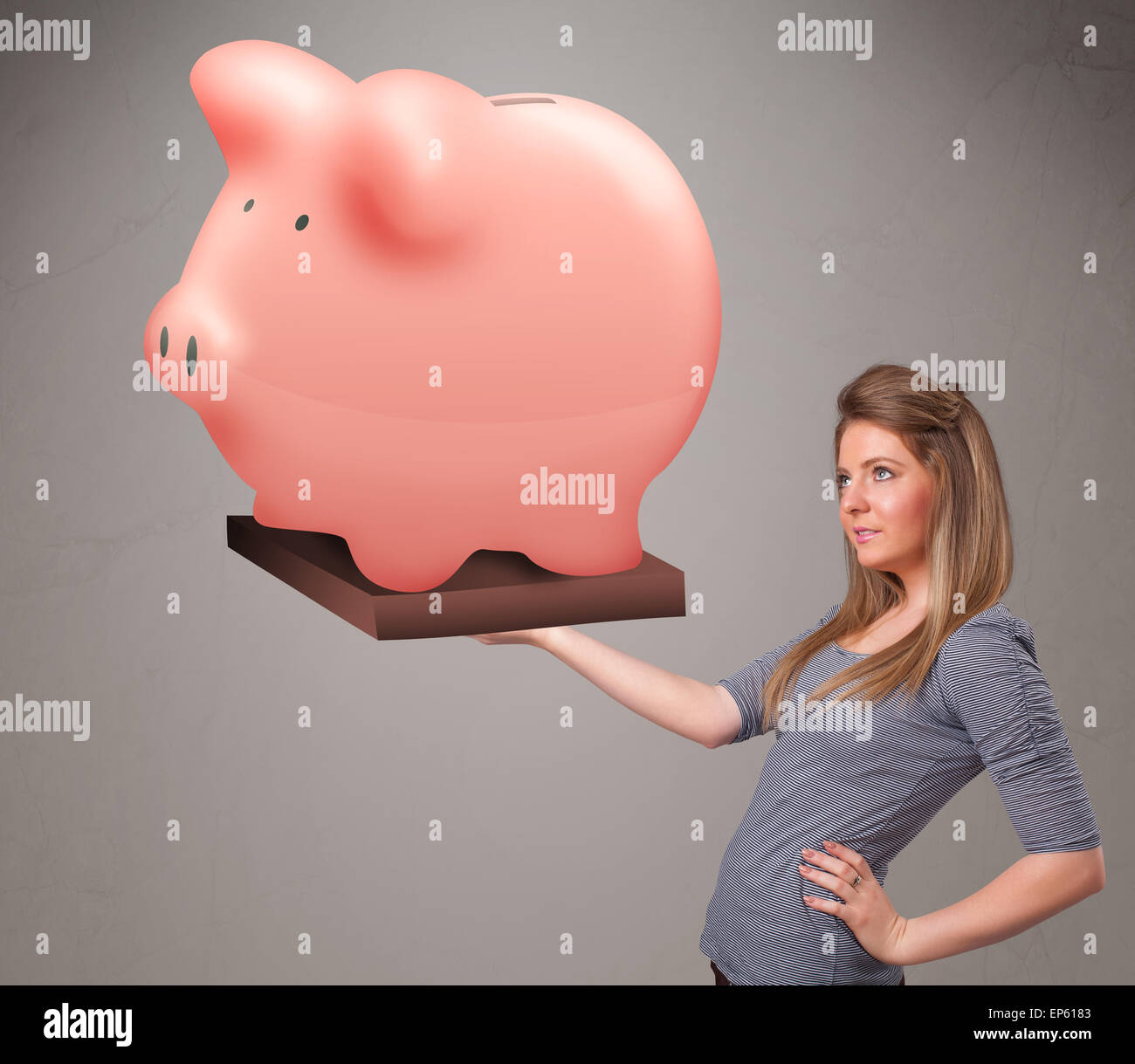 Young girl holding a huge savings piggy bank Stock Photo - Alamy