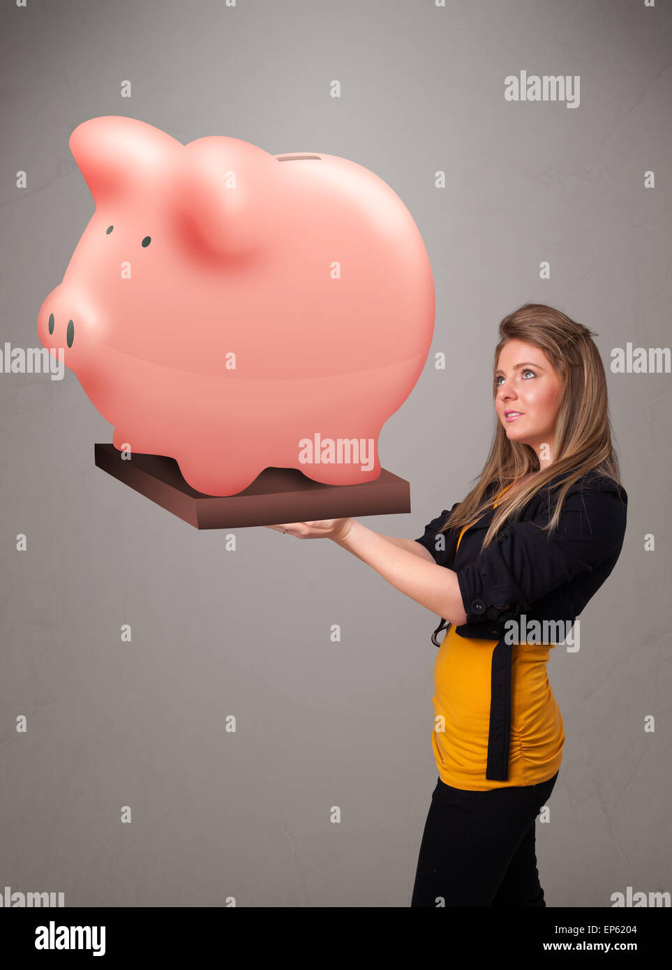 Young girl holding a huge savings piggy bank Stock Photo - Alamy