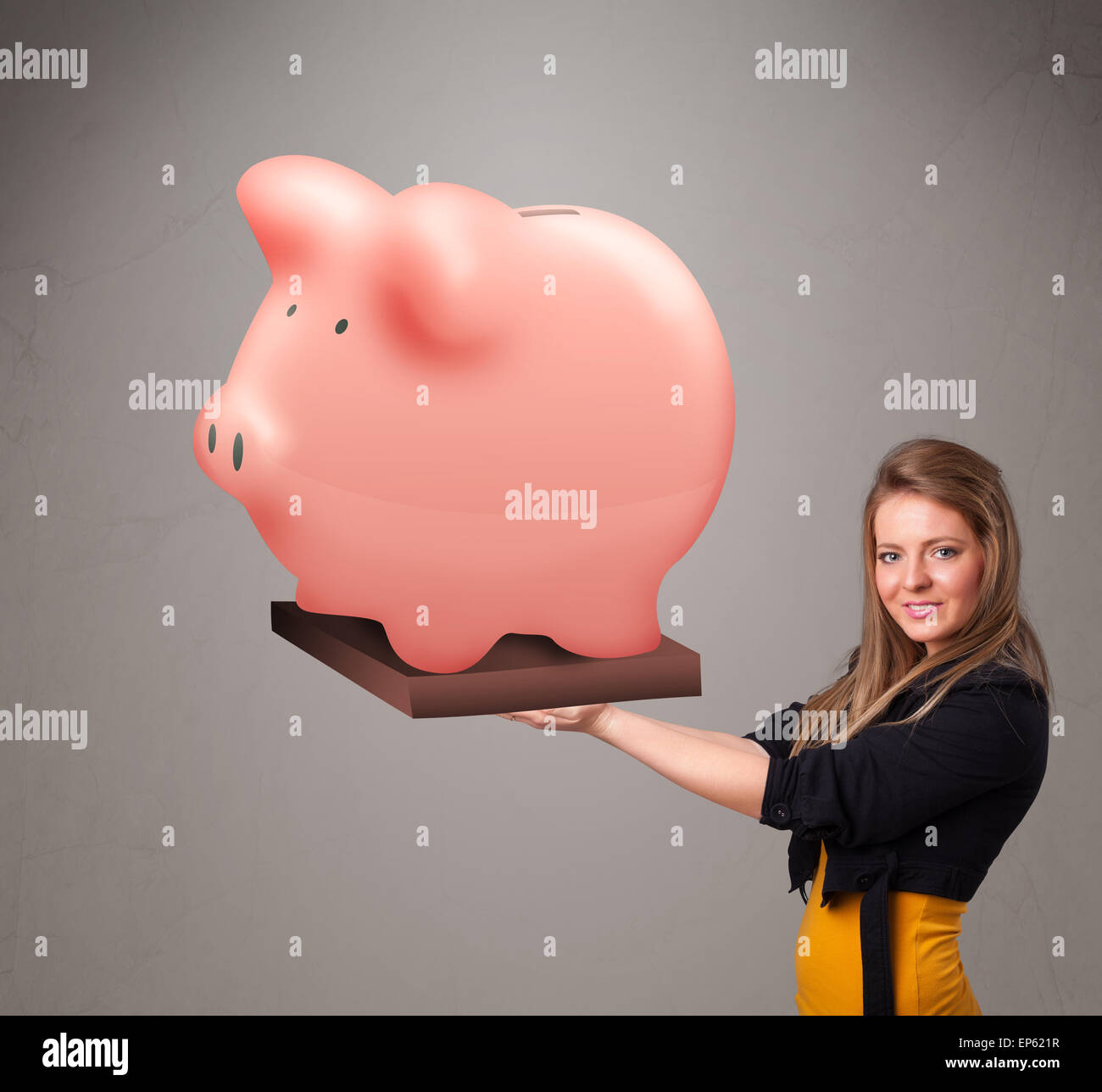 Young girl holding a huge savings piggy bank Stock Photo - Alamy