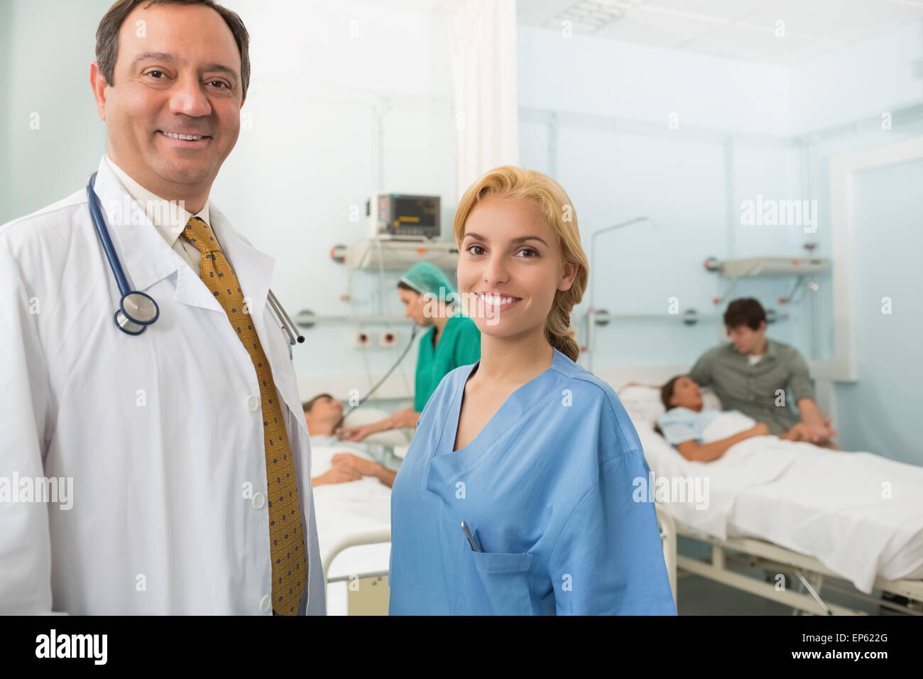 Smiling doctor and nurse talking in a hospital room Stock Photo - Alamy