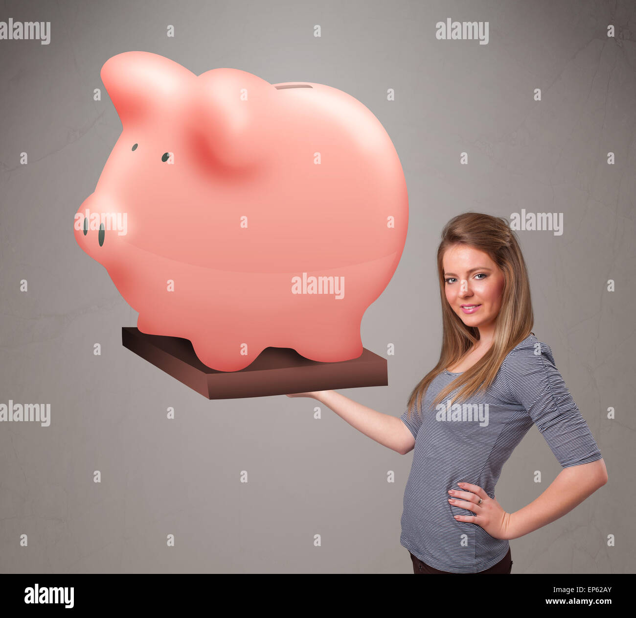 Young girl holding a huge savings piggy bank Stock Photo - Alamy