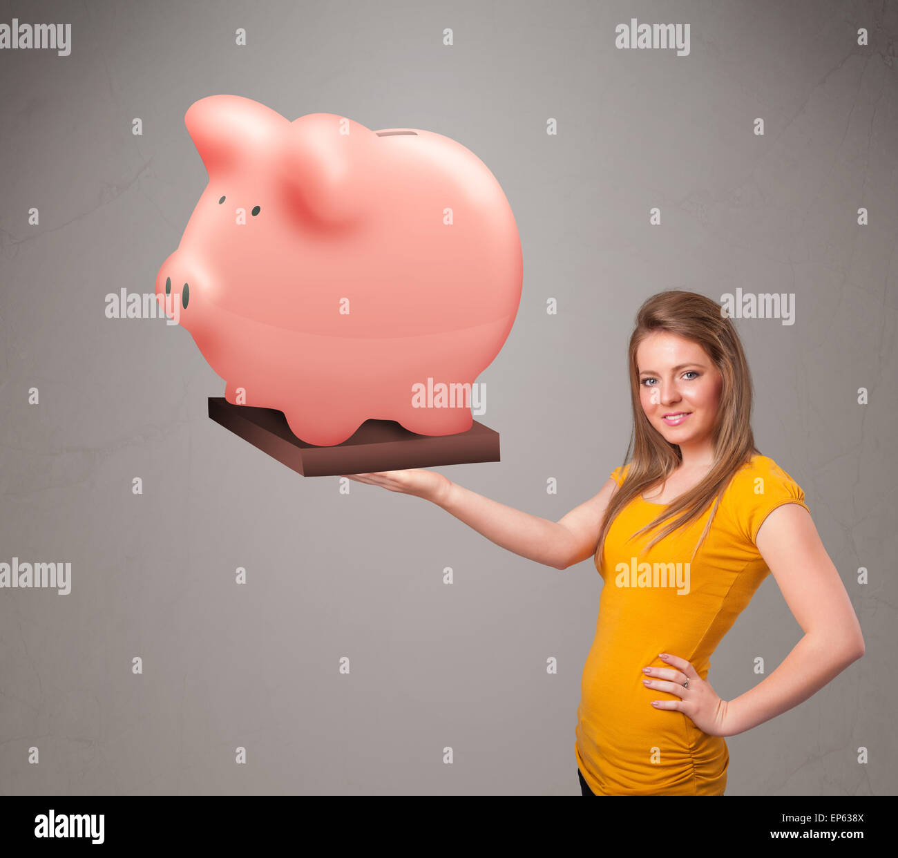 Young girl holding a huge savings piggy bank Stock Photo - Alamy