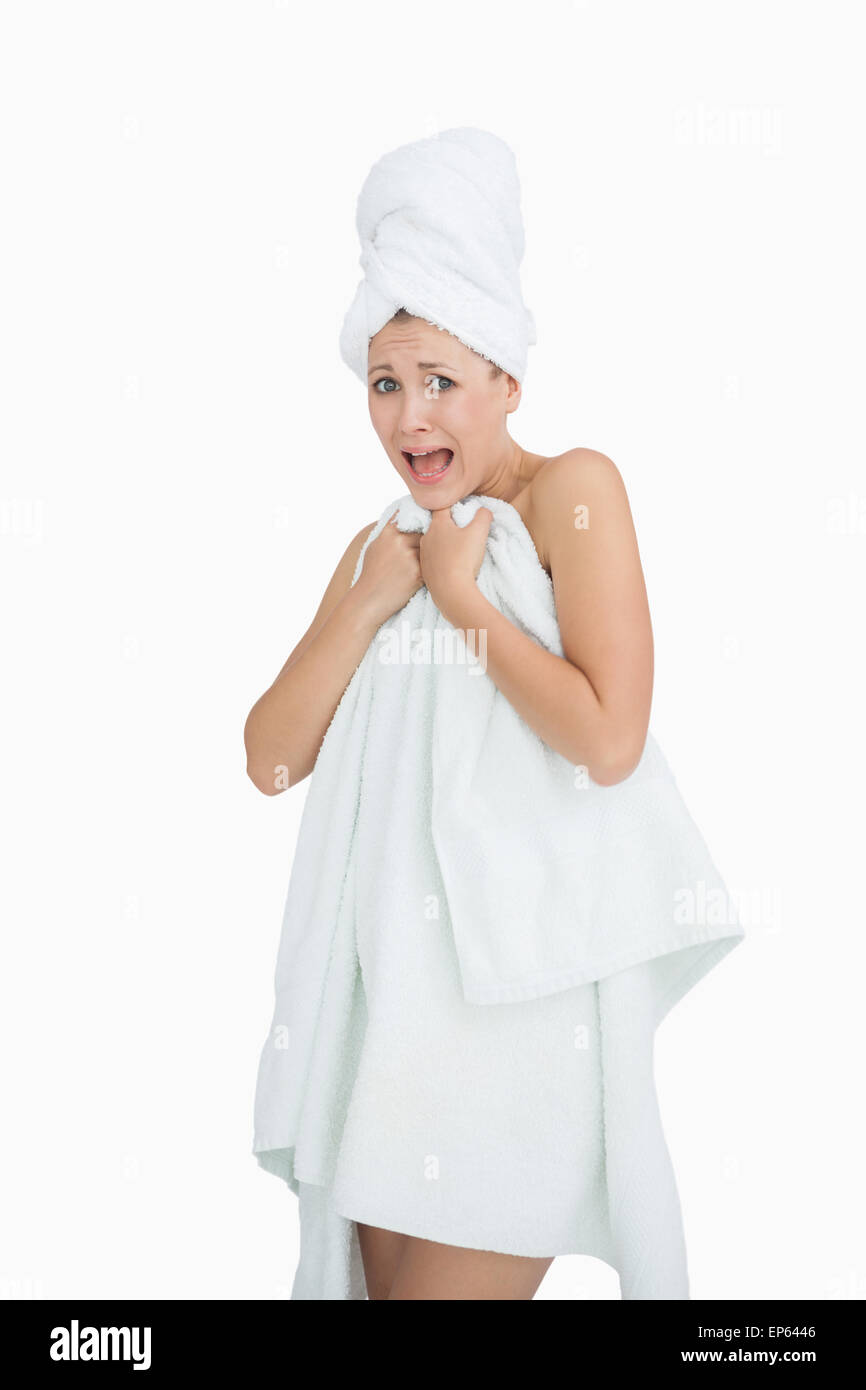 Portrait of woman screaming as she covers herself with towel Stock ...