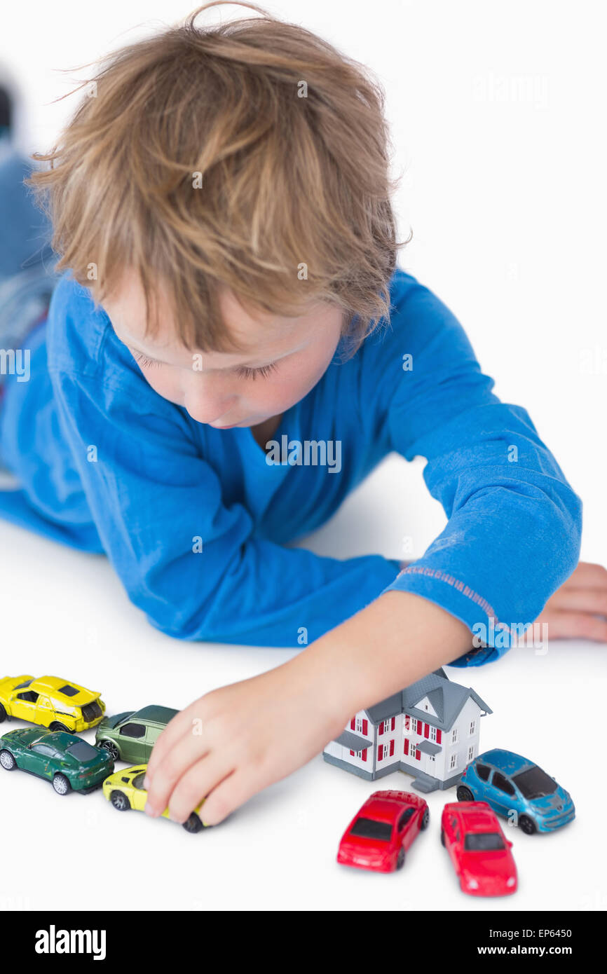 Closeup of boy playing with playhouse and toy cars Stock Photo - Alamy