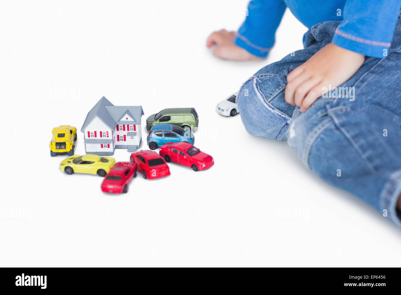 Closeup of boy playing with playhouse and toy cars Stock Photo - Alamy