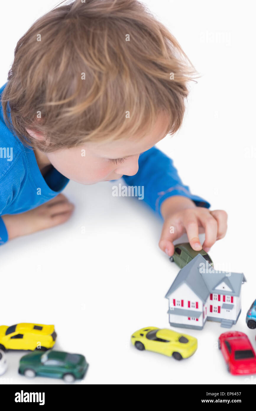 Closeup of boy playing with playhouse and toy cars Stock Photo - Alamy