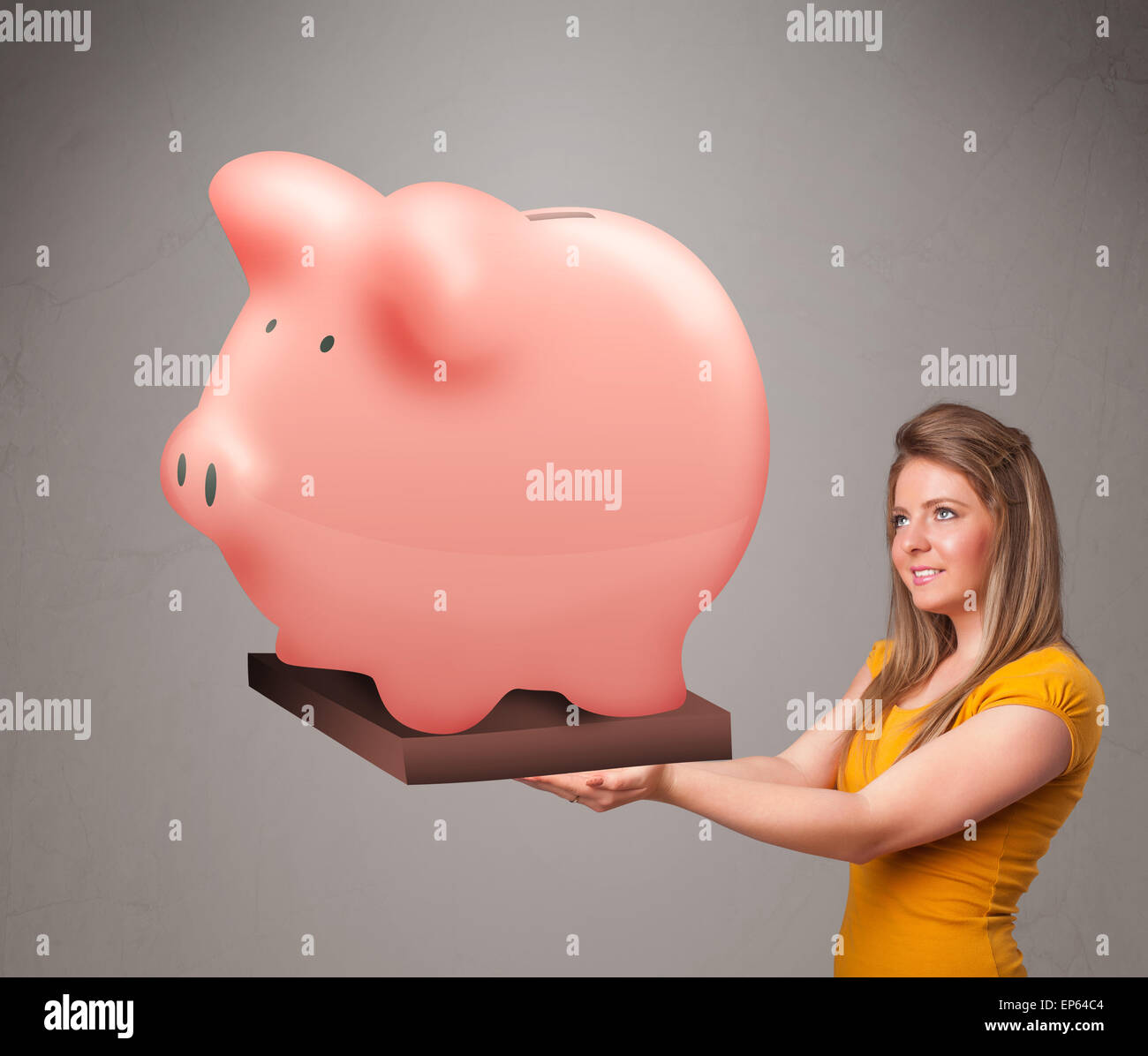 Young girl holding a huge savings piggy bank Stock Photo - Alamy