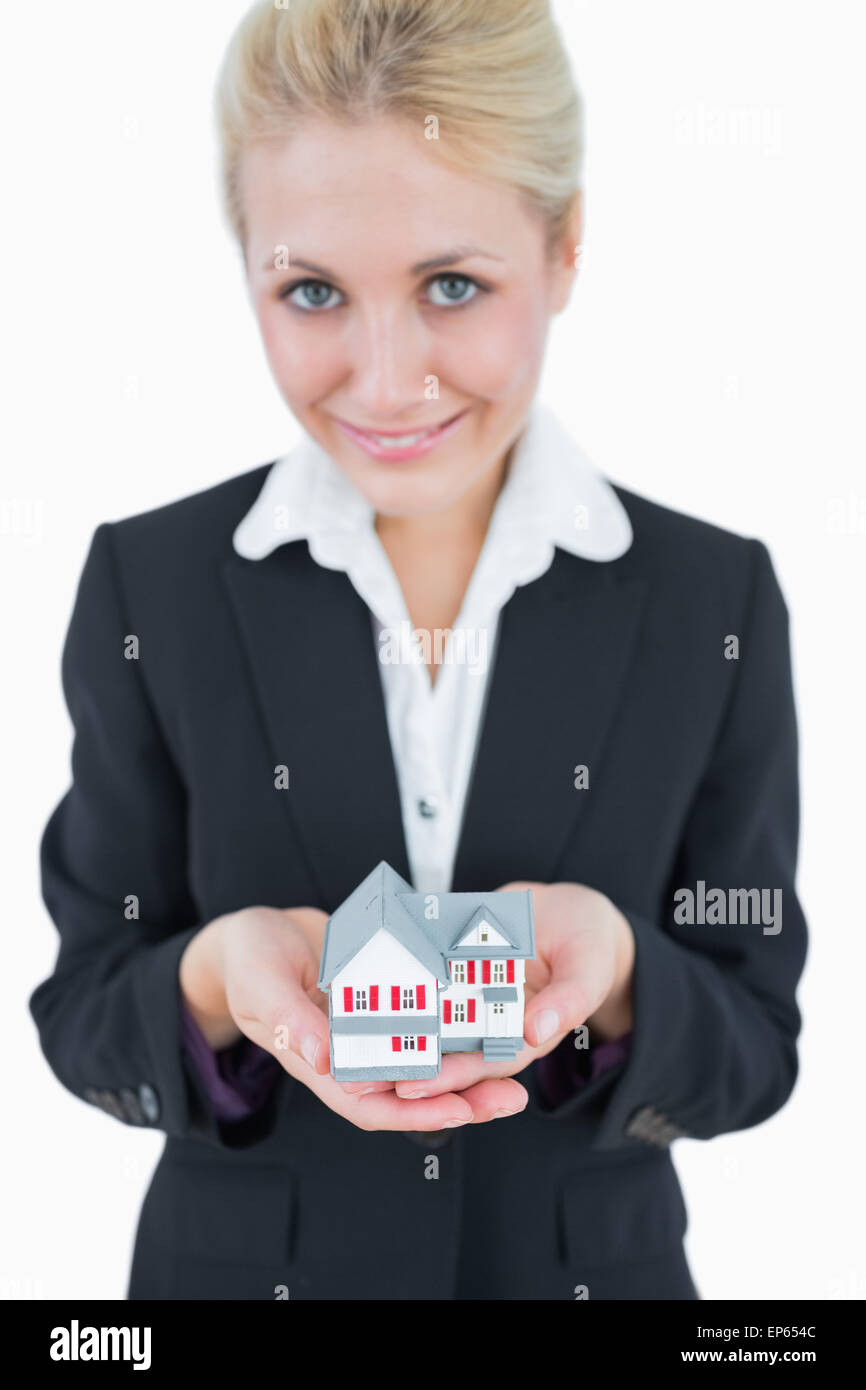 Portrait of business woman holding model house Stock Photo - Alamy