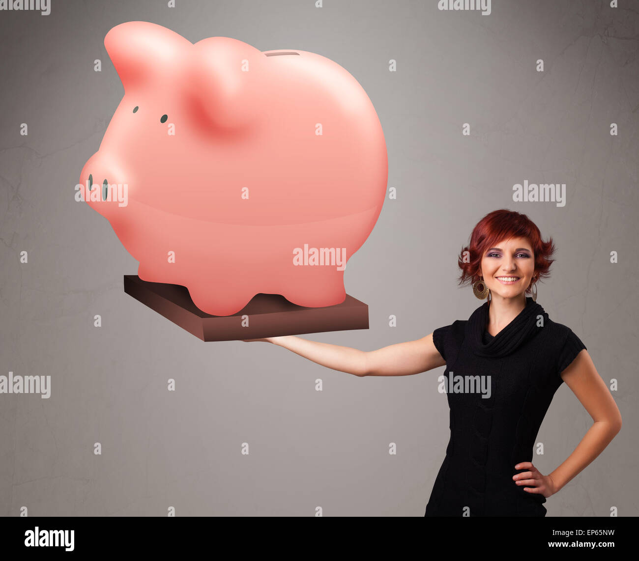 Young girl holding a huge savings piggy bank Stock Photo - Alamy