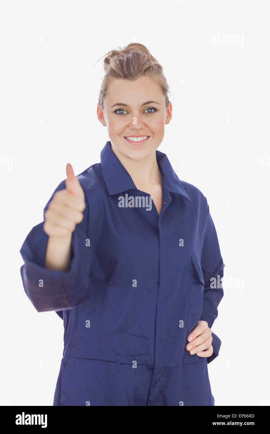 Female technician witth hand on waist showing thumbs up sign Stock Photo