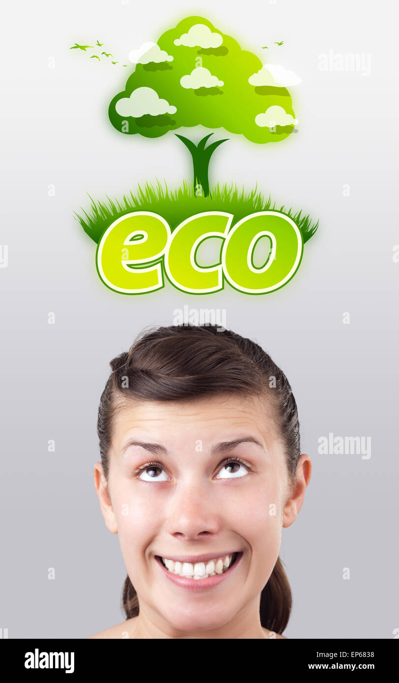 Young girl looking at green eco sign Stock Photo