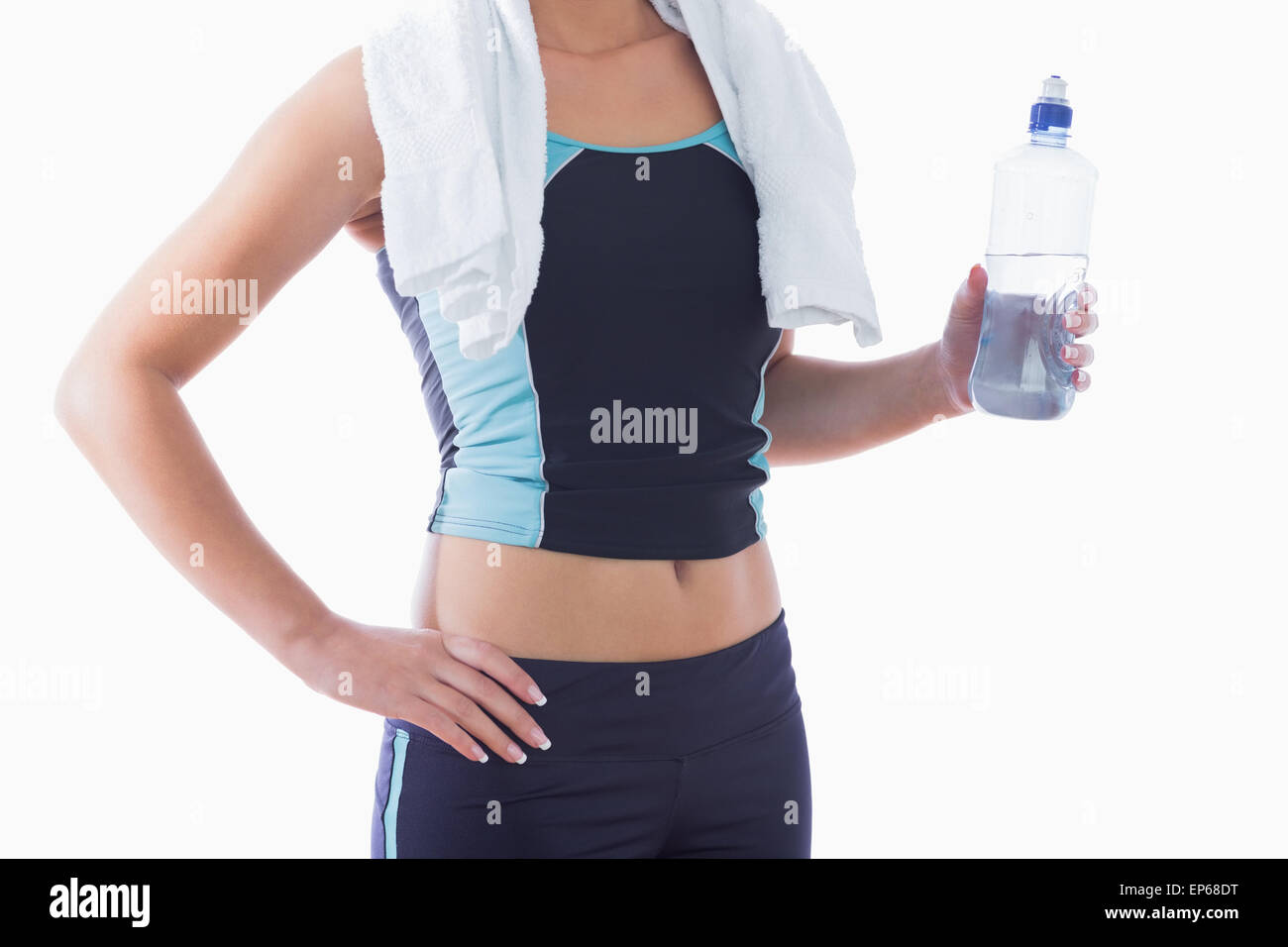 Sporty woman with towel around neck and water bottle Stock Photo - Alamy