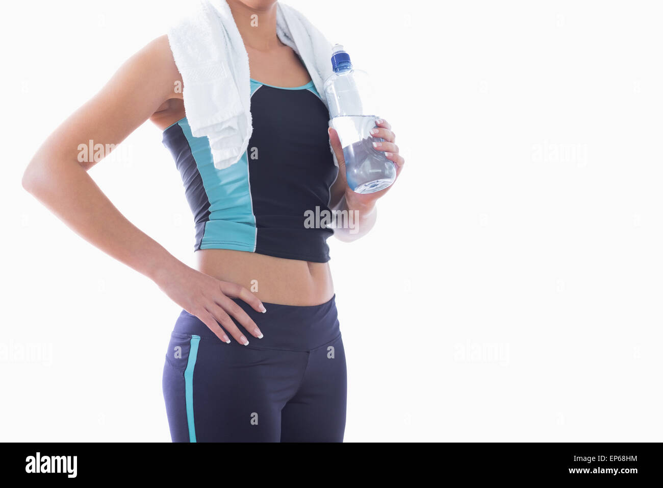 Sporty woman with towel around neck and water bottle Stock Photo - Alamy