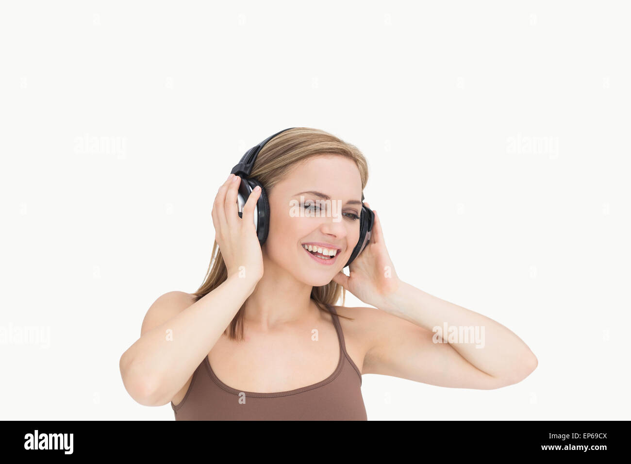 Young woman listening music through headphones Stock Photo - Alamy