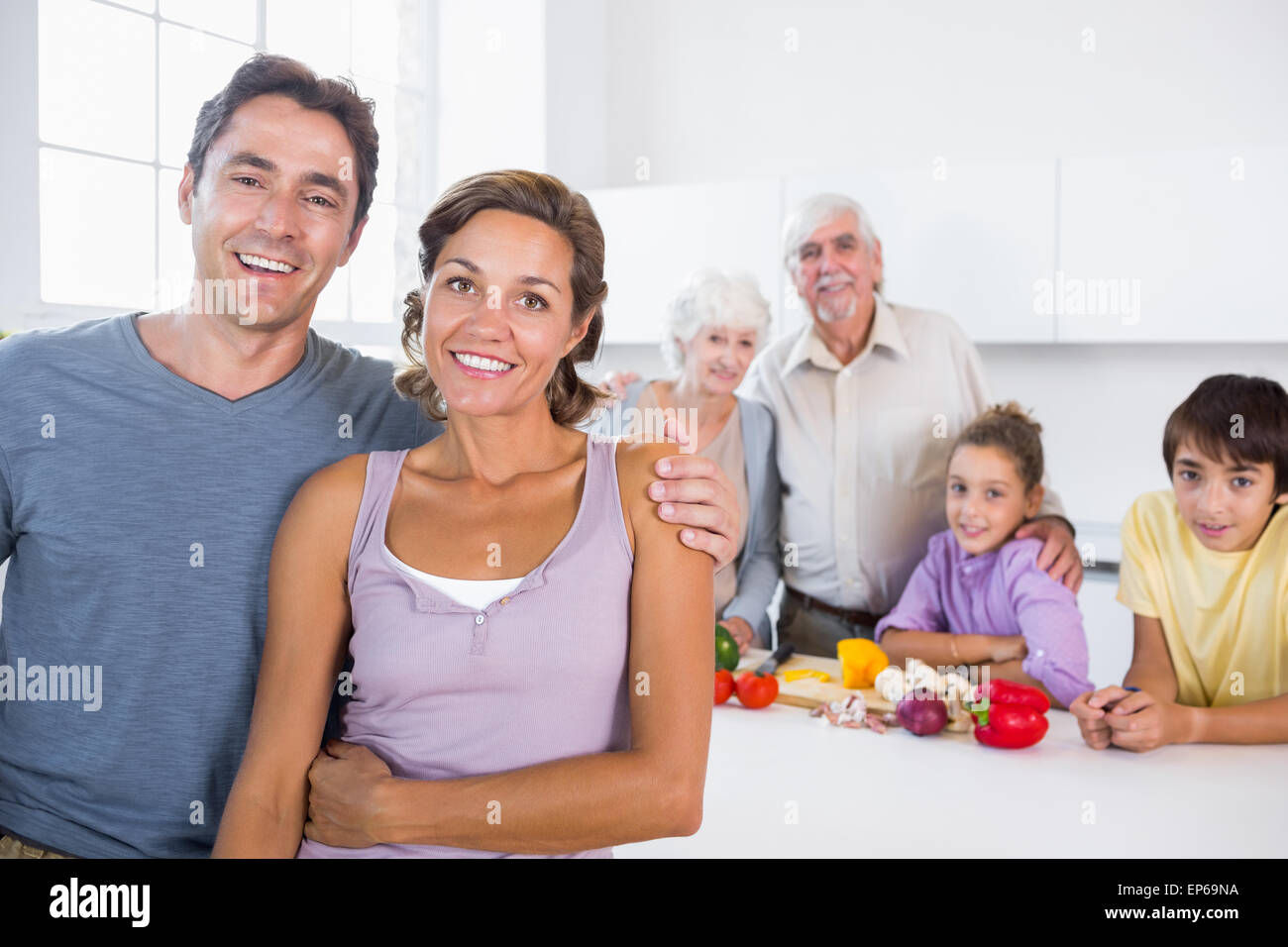 Mother and father standing by kitchen counter Stock Photo - Alamy