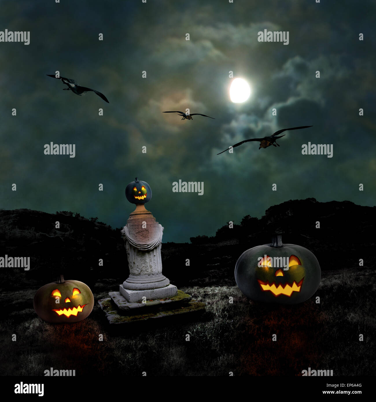 Halloween pumpkins in the yard of an old house at night in the bright ...