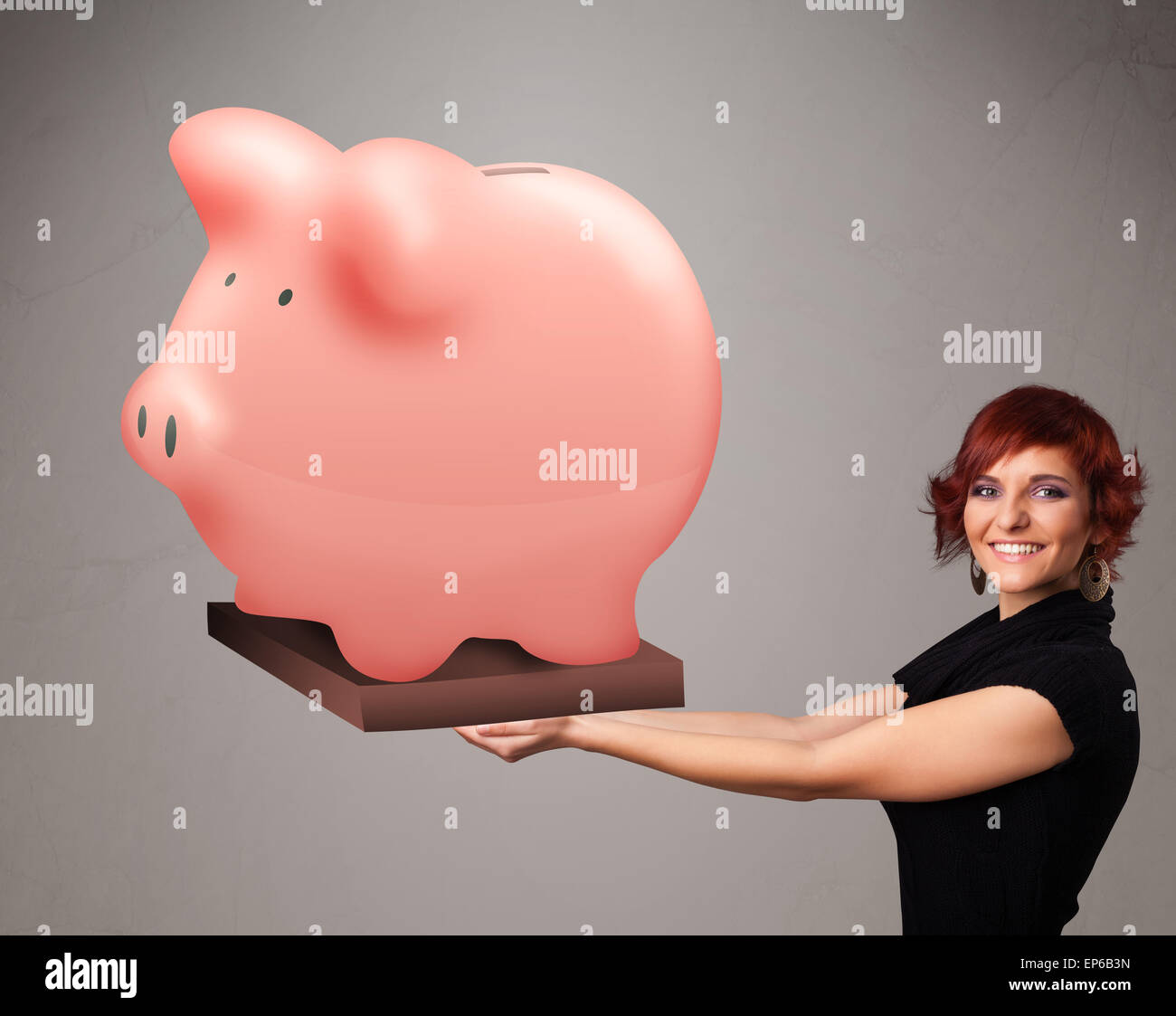 Young girl holding a huge savings piggy bank Stock Photo - Alamy