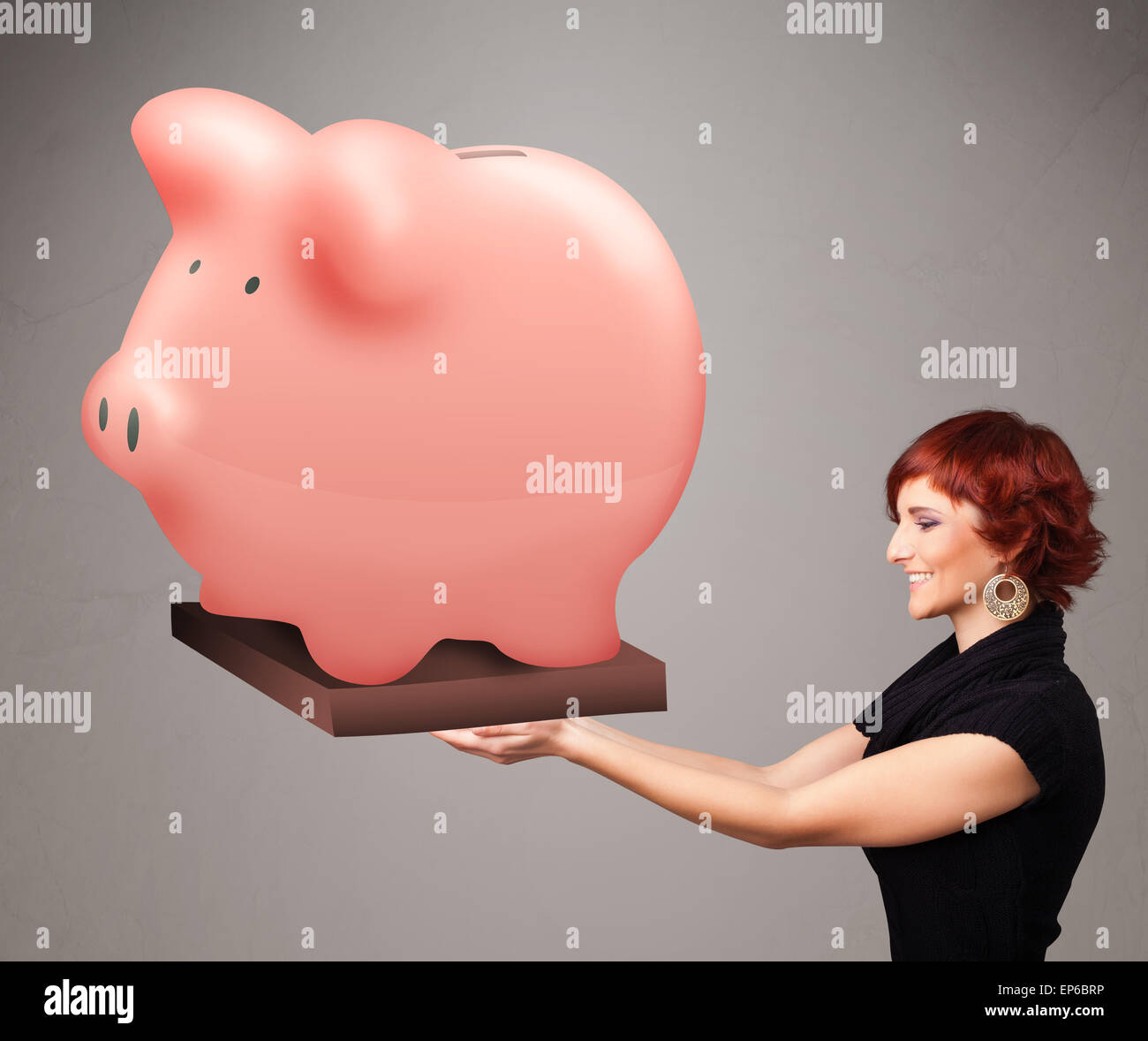 Young girl holding a huge savings piggy bank Stock Photo - Alamy
