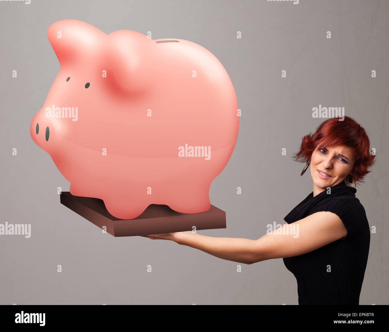Young girl holding a huge savings piggy bank Stock Photo - Alamy