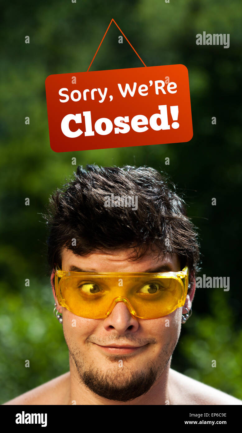 Close. Sign Head Young persons head looking at closed and open signs Stock Photo - Alamy