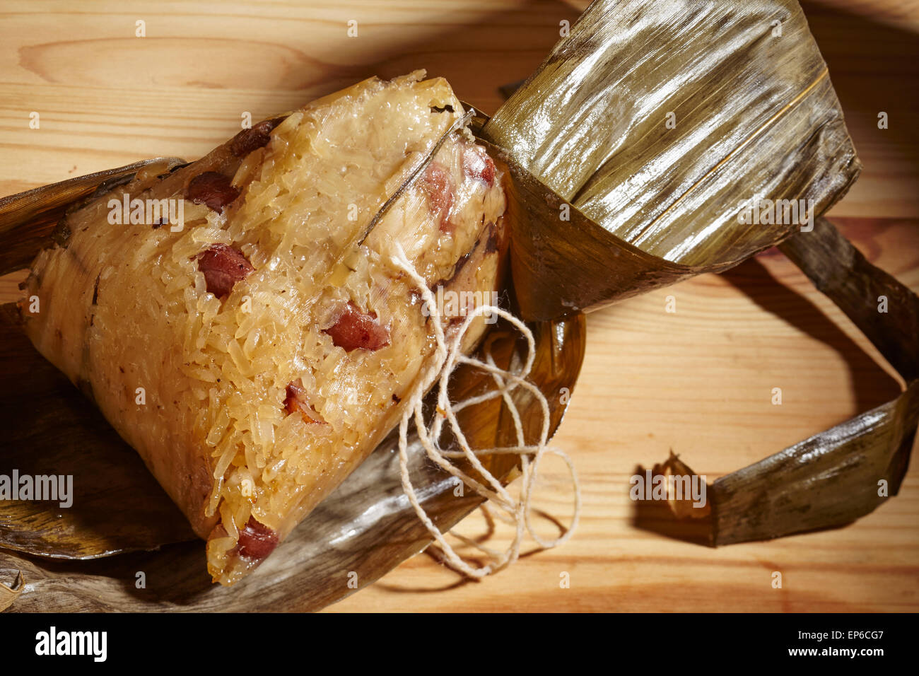 Lotus Leaf stuffed with sticky rice, a typical southern Chinese street food snack. Called 'Lo Mai Gai' in Cantonese. Stock Photo