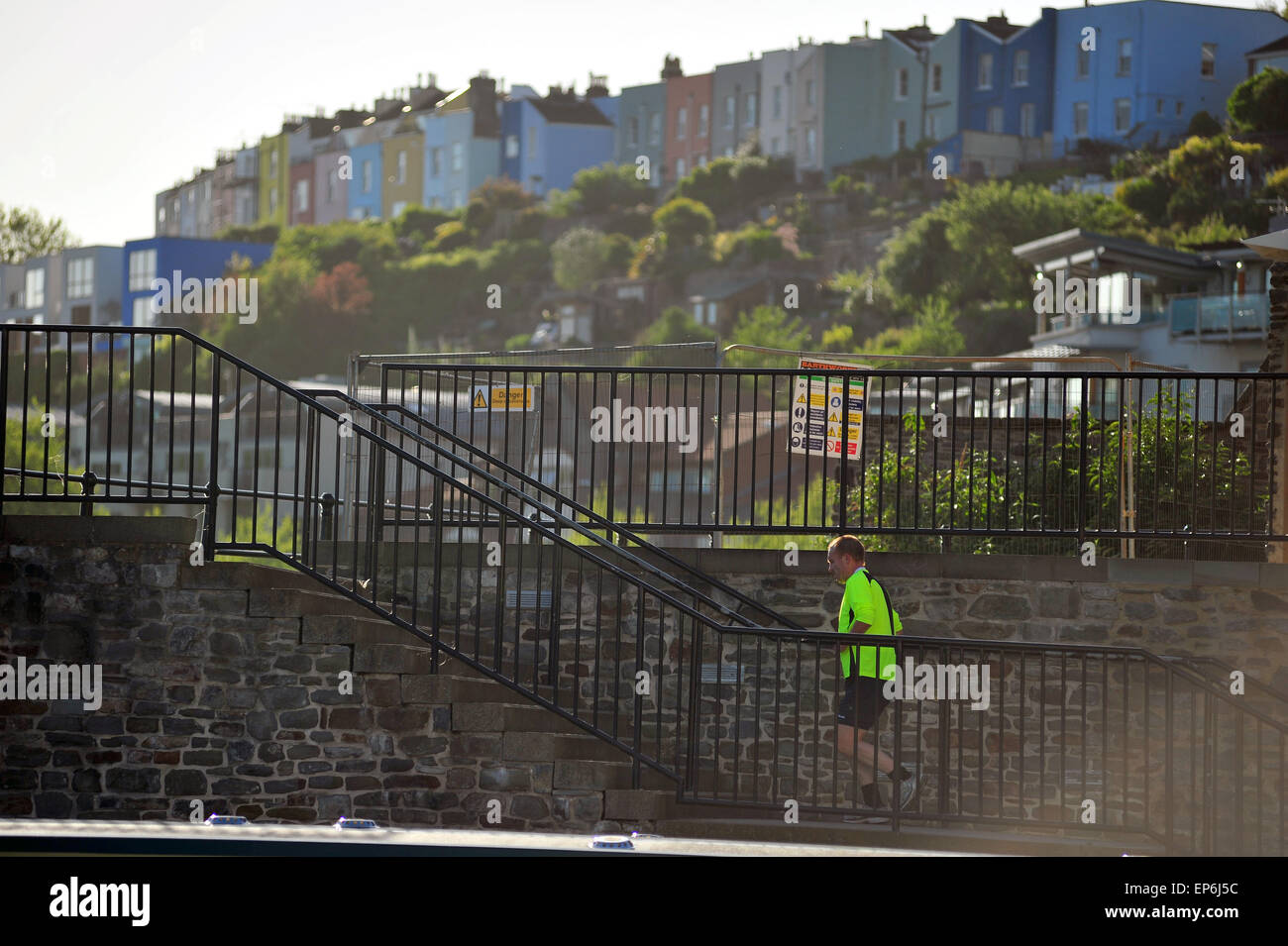 A male jogger runs up some steps at the side of Bristol Harbour in Bristol. Stock Photo