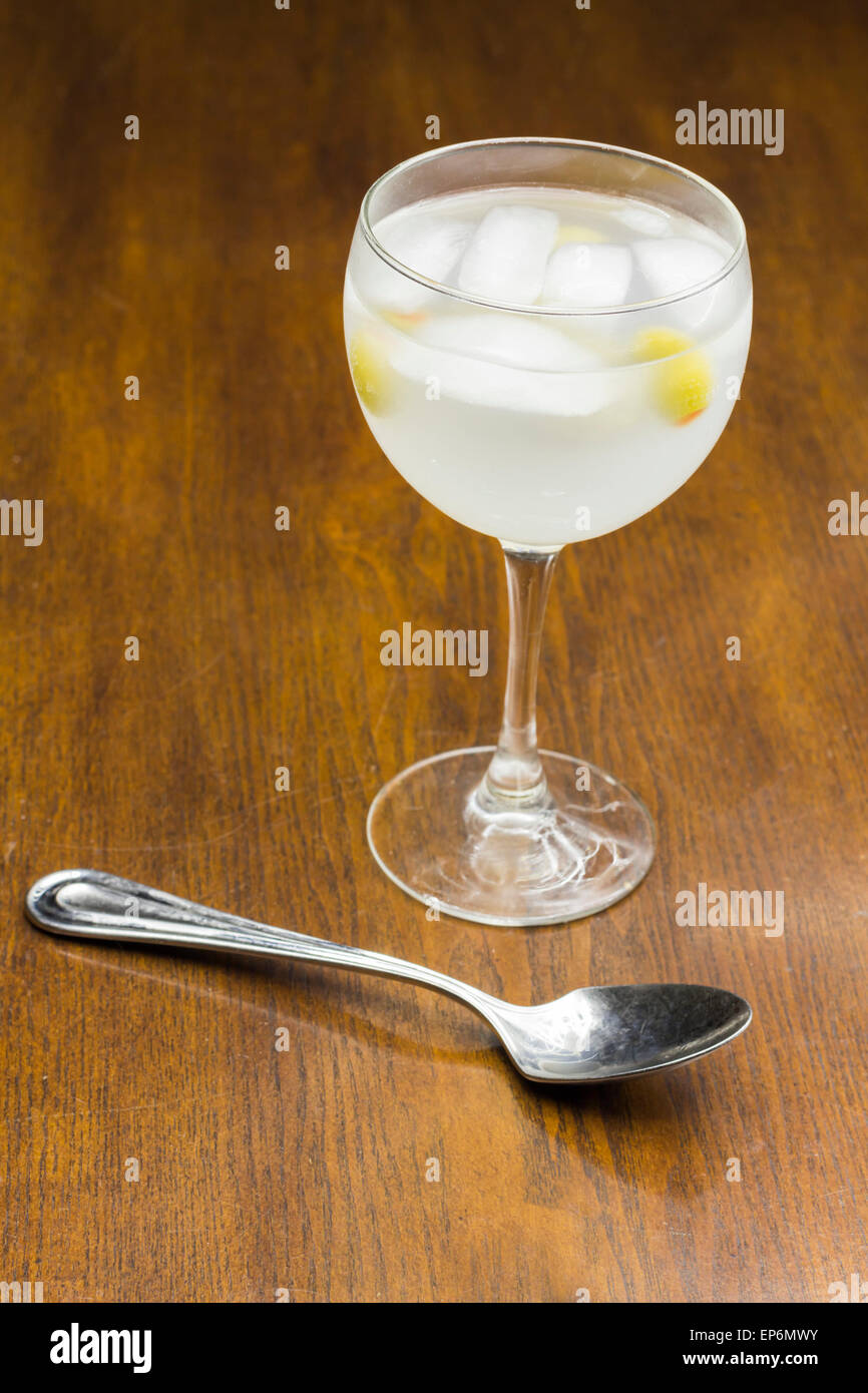 Gin and tonic with green olives and ice on a bar table Stock Photo Alamy
